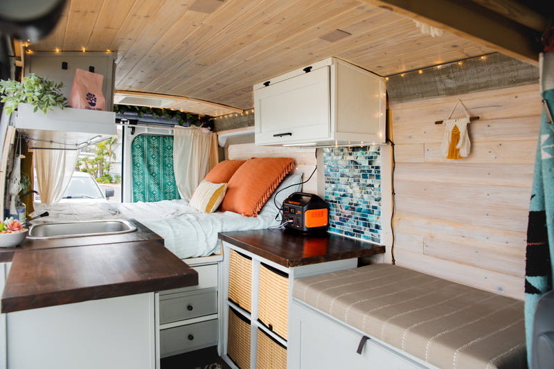 Experience mobile living in this cozy RV rental! Features a comfy bed, compact kitchen, storage, and ambient lighting. Ideal camper van. — photo 6