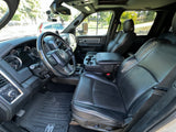 Detailed view of a Ram Power Wagon truck's spacious black leather interior & dashboard, ideal for rv rental.