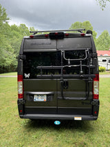 Rear view of a gray Thor Motor Coach Sequence camper van with a WV plate & Thule bike rack, perfect for your rv rental.
