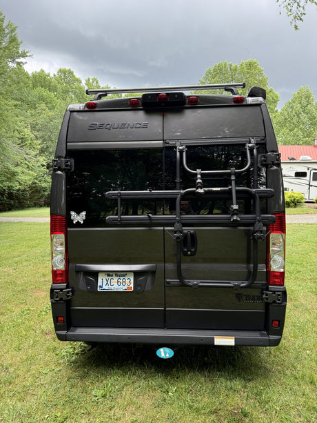Rear view of a gray Thor Motor Coach Sequence camper van with a WV plate & Thule bike rack, perfect for your rv rental.