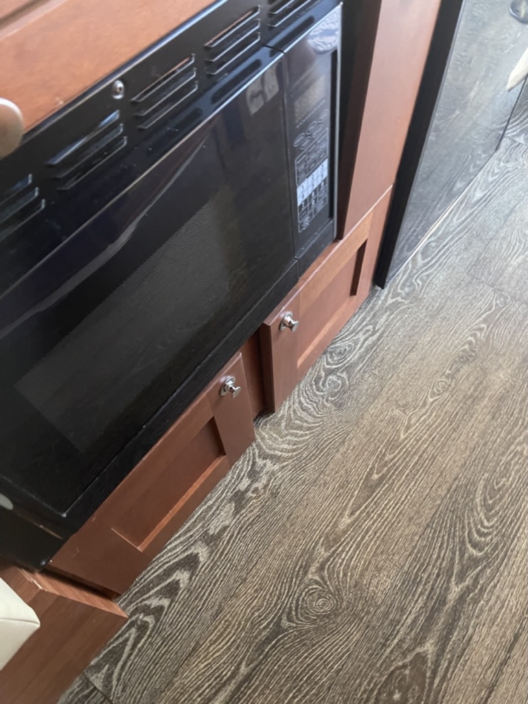  and a window revealing trees and grass.|Inside an RV rental — photo 12