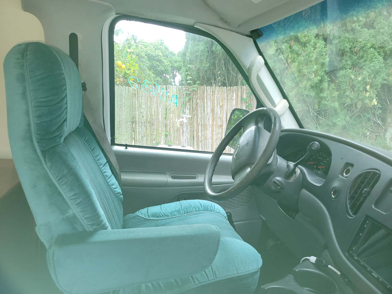  flanked by fruit trees and a blue house.|Cozy RV rental interior with bed — photo 3