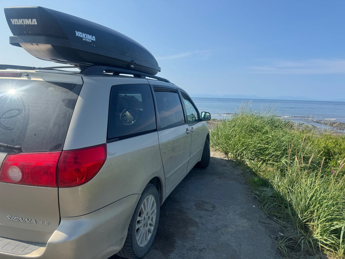  offering adventure akin to an RV rental.|Minivan with roof box by the sea — photo 3