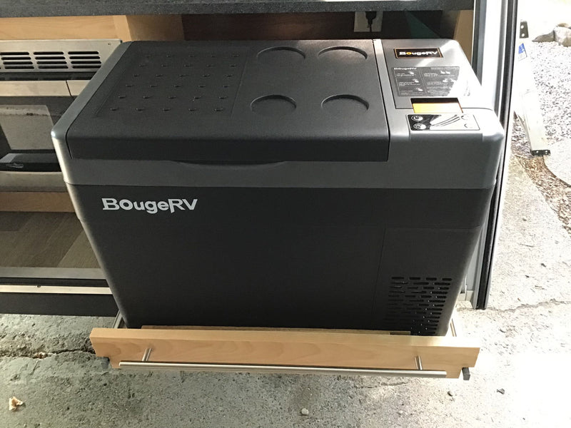 A BougeRV portable fridge/freezer on a pull-out slide, an essential appliance for any RV rental or camper van. — photo 13