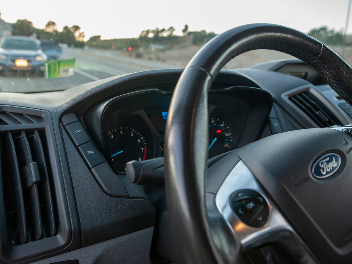  parked on a scenic road.|Explore in this silver Ford Transit rv rental van — photo 8