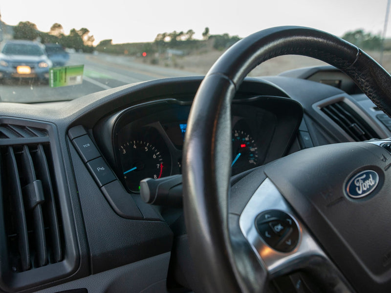  parked on a scenic road.|Explore in this silver Ford Transit rv rental van — photo 8