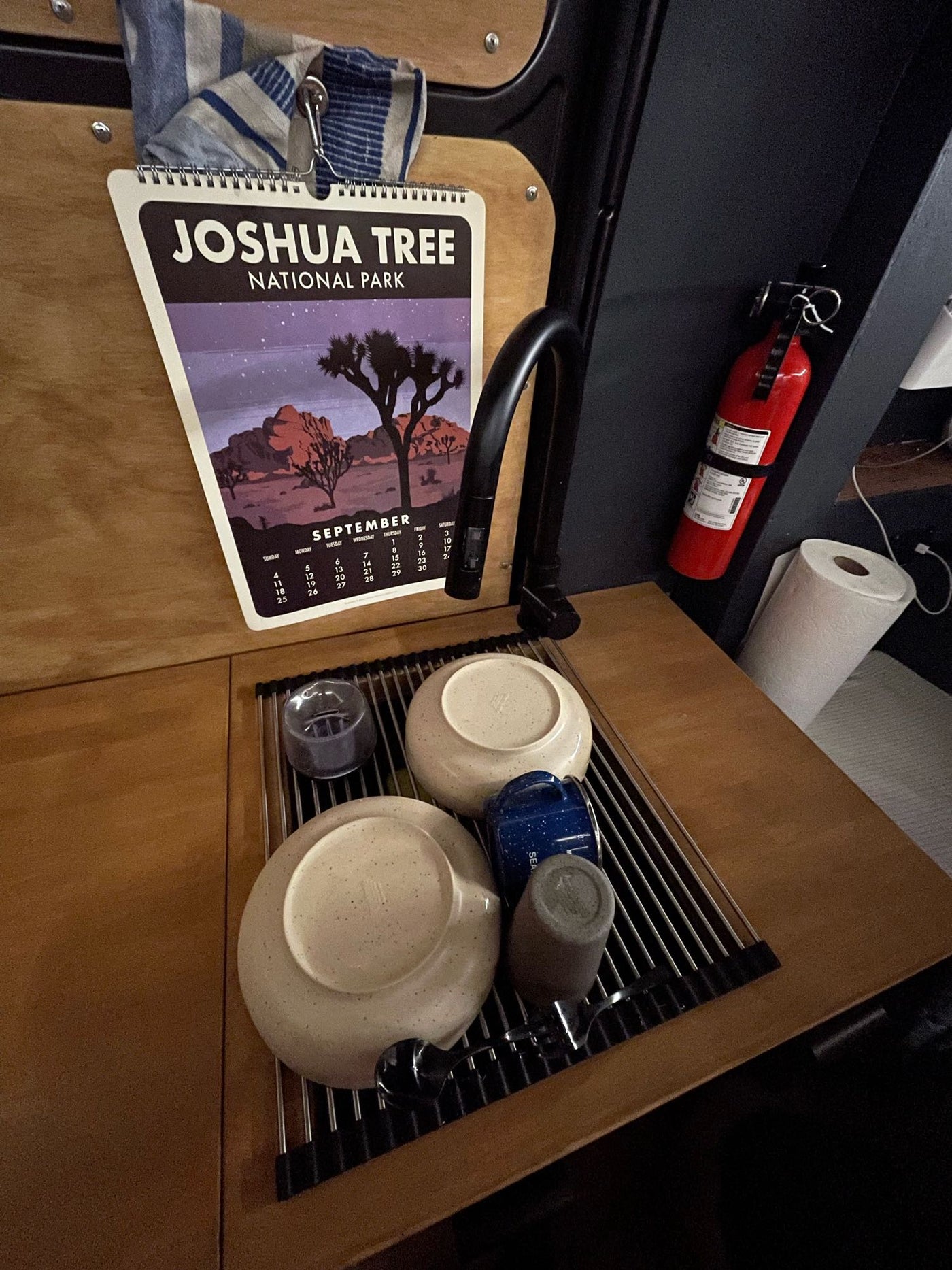  parked on a scenic road with an open door. Ready for van life adventures!|RV rental: Table set with a plate — photo 17