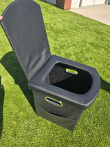 Compact black portable toilet with handles on artificial grass, great for your RV rental camping.