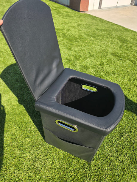 Compact black portable toilet with handles on artificial grass, great for your RV rental camping.