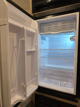 Clean, empty compact refrigerator inside an RV rental, ready for your adventure.