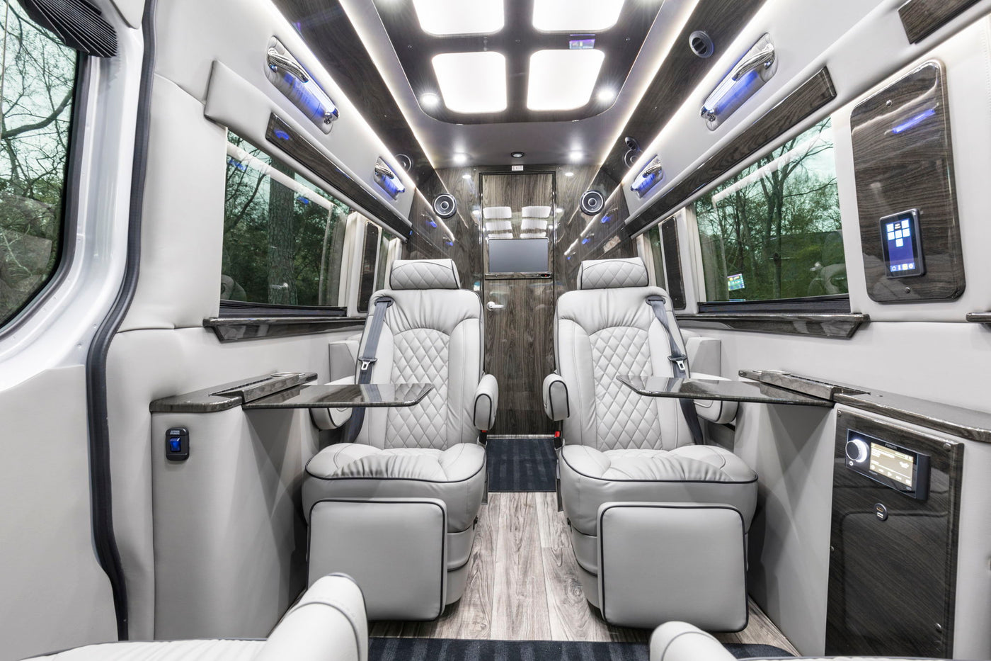  ideal for your next RV rental adventure. Parked by a basketball hoop.|High-end RV rental interior: Two plush — photo 2