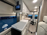 Inside a well-equipped rv rental: kitchenette, seating, and Winegard mobile internet system for your adventures.