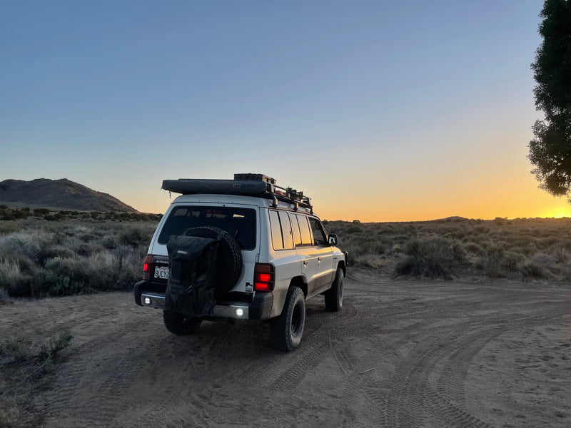 White adventure SUV on a dusty trail at sunset in the desert. Perfect for a rugged rv rental trip. — photo 17