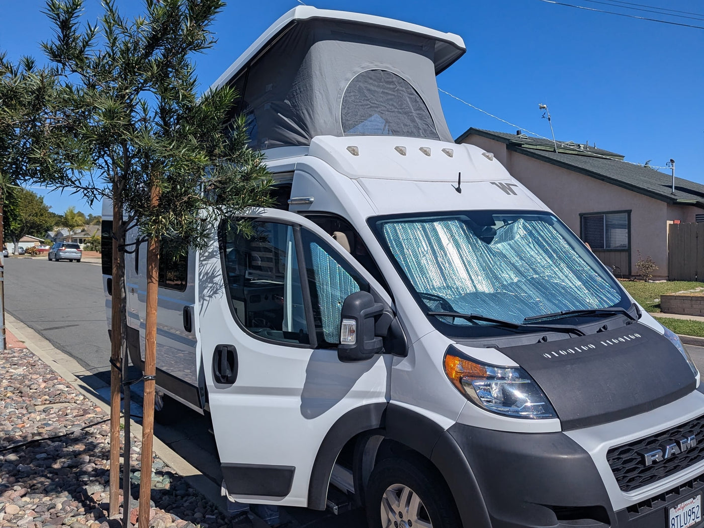  backed by stunning snow-dusted mountains & pine trees. Ideal for a scenic outdoor escape.|White Ram ProMaster camper van RV rental with pop-top roof & sunshades — photo 2
