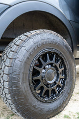 Rugged Toyo Open Country A/T tire and Black Rhino wheel on an RV rental, ready for off-road adventures.
