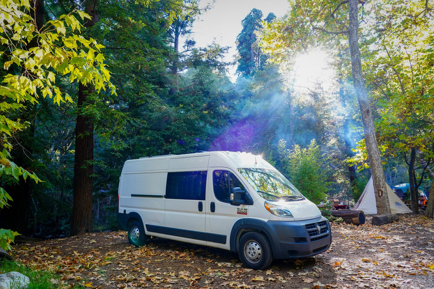  and comfy bench seating.|Bright RV rental interior features a mini kitchen with sink — photo 2