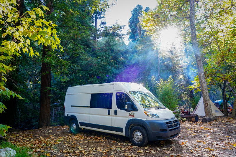  and comfy bench seating.|Bright RV rental interior features a mini kitchen with sink — photo 2