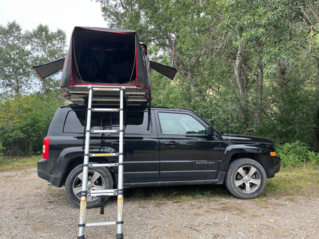  a great alternative to RV rental for outdoor adventure.||Black Jeep Patriot SUV with a deployed iKamper rooftop tent