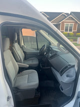 RV rental van interior: View of three front seats, dashboard, and outside house. Ready for your next trip.