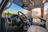 Inside this RV rental, experience the well-appointed van cabin with a clear view of the dashboard, steering wheel, and comfy seats.