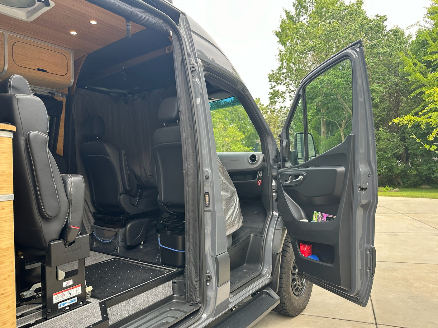 RV rental: Custom van conversion's interior with modular seating, wood ceiling, and practical design for travel.