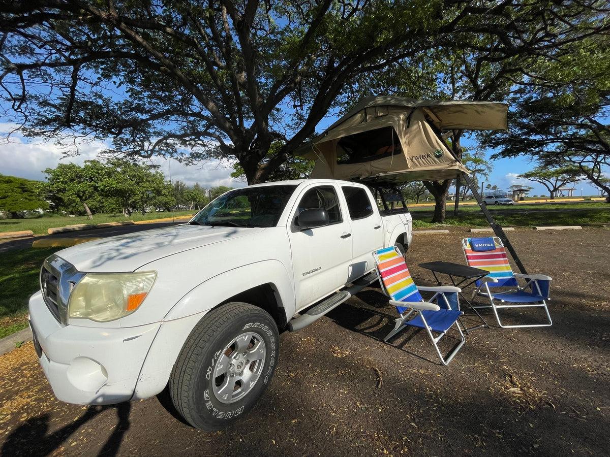Ready for adventure! This white Toyota Tacoma with a rooftop tent & camping chairs offers a unique RV rental experience. — photo 9