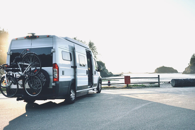  and outdoor shoes for nature travel.|Enjoying an RV rental adventure: a camper watches Netflix projected on the van's side — photo 4