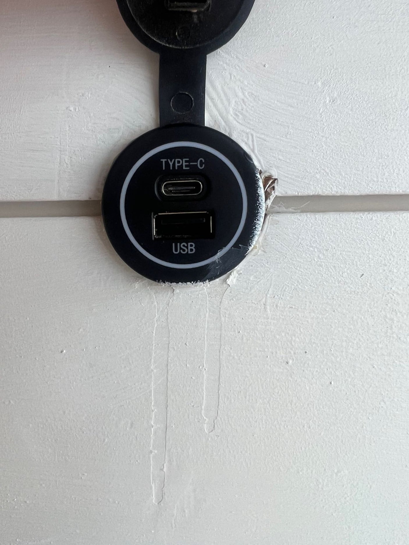 RV rental feature: A black dual USB-C and USB-A charging port mounted on a white wall panel, ready for devices.