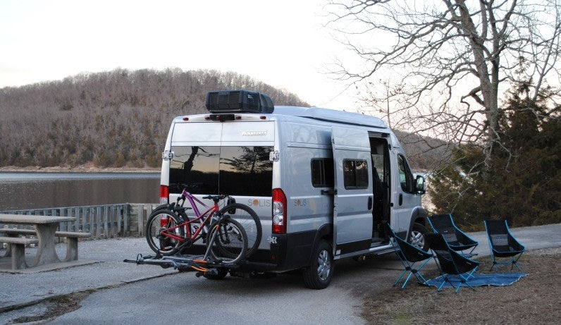 This Winnebago Solis rv rental is ready for lakeside camping, equipped with bikes & chairs for outdoor adventure.