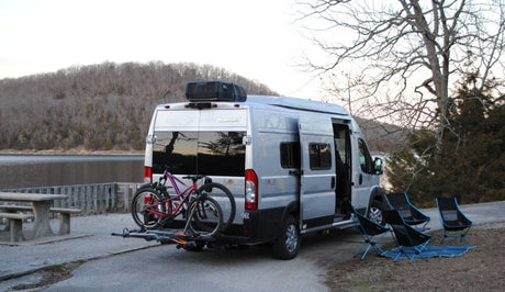This Winnebago Solis rv rental is ready for lakeside camping, equipped with bikes & chairs for outdoor adventure.