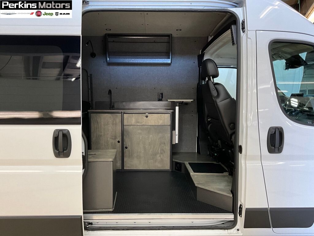  showcasing a versatile interior. Perfect for your next rv rental adventure.|**Inside a white camper van: kitchenette with sink/cabinets — photo 2