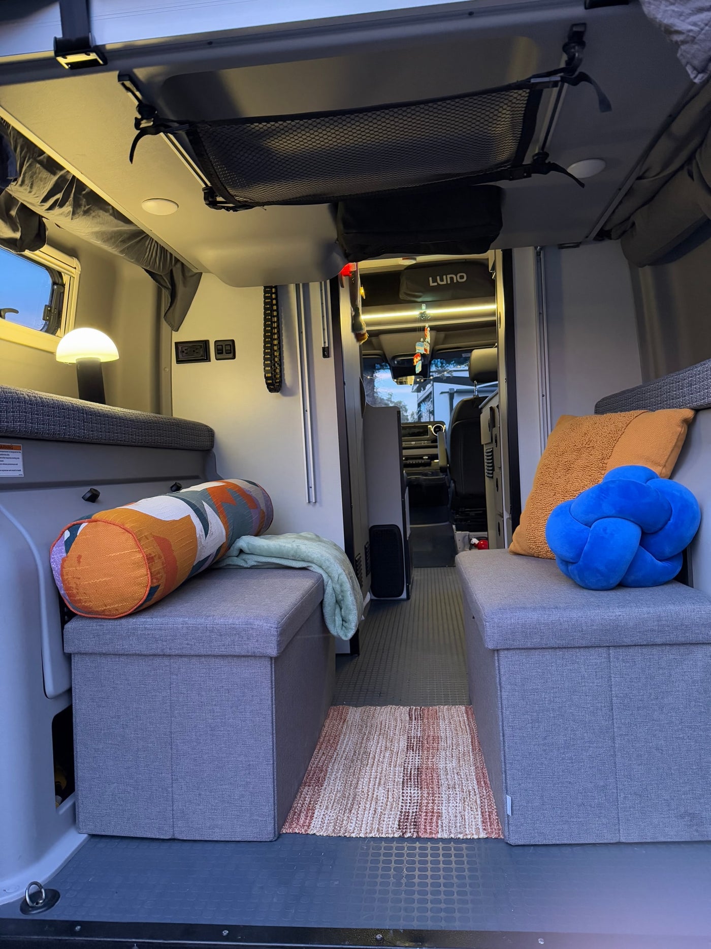 Cozy RV rental interior with convertible benches, ambient lighting, and clever storage solutions for travelers. — photo 15