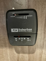RV rental climate control: Black Suburban thermostat. Top slider is OFF. Bottom shows 60°F/16°C setting for comfort.