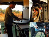  enjoying quality leisure time together.|A person enjoys a breathtaking desert view from a cozy rv rental bed. The perfect setup for van life road trips.|RV rental: A man maintains a bike wheel