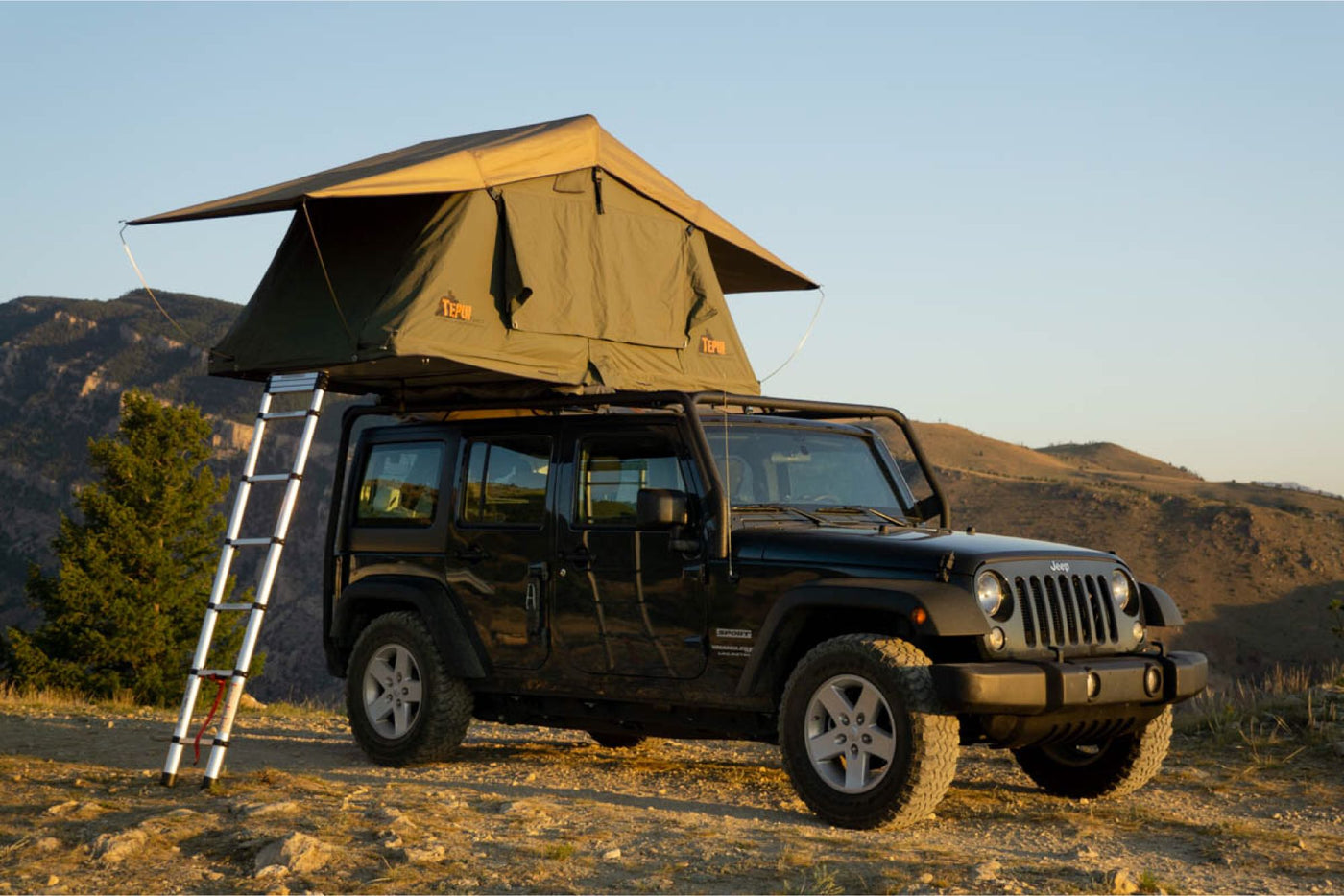  ideal for overland RV rental adventures under a stunning sunset sky.|Dark Jeep Wrangler with roof cargo box on a snowy road in Montana. Perfect for rugged winter adventures — photo 7