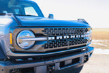 Close-up of a dark Ford Bronco's front grille & headlight. This rugged SUV offers more adventure than a typical rv rental.