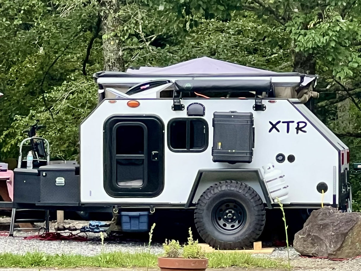  set for adventure. Consider this RV rental for your next trip.|Enjoy a unique rv rental experience! Friends relax under a Falcons canopy — photo 2