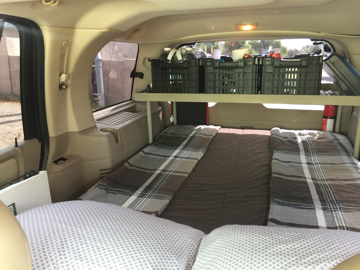 RV rental interior: A car transformed into a comfortable sleeping space with a bed