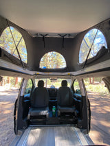 Experience the spacious interior of this rv rental, featuring a raised pop-top roof for panoramic views & comfortable front seating.
