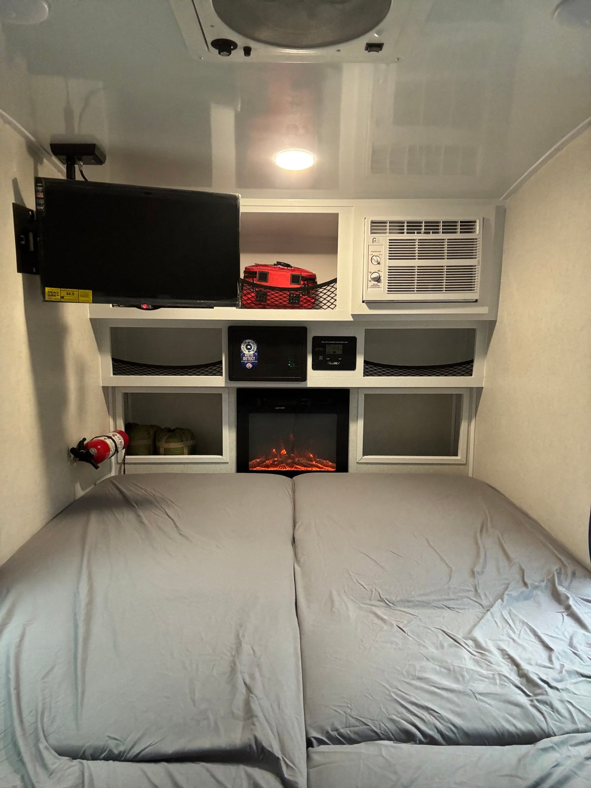 Cozy RV rental bedroom featuring a TV