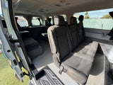 RV rental van interior with passenger seating and a versatile custom rear area. Grey carpet floor. Ready for your journey.