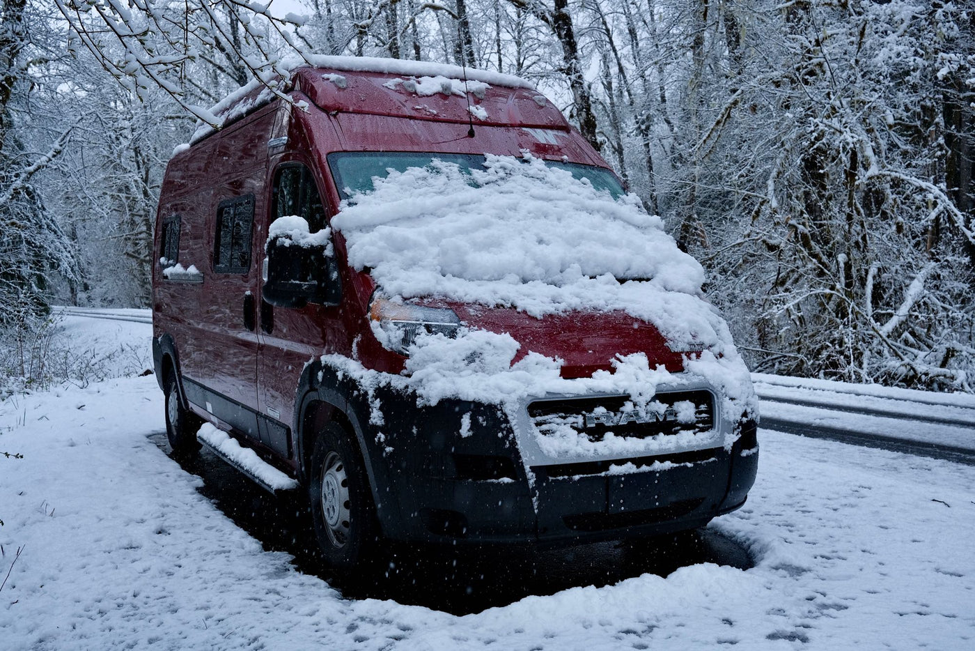  ideal for an RV rental.|Red Winnebago Solis rv rental parked on a wet road — photo 6