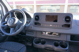 Dashboard of a modern Mercedes-Benz van, featuring the steering wheel, large central screen, and controls. Ready for your next RV rental adventure.