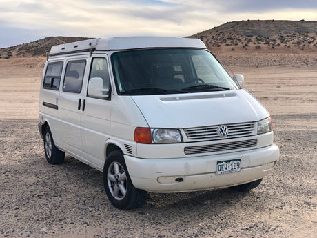 White VW camper van, ideal for your next RV rental adventure parked in a desert landscape.