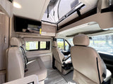  and sleek wooden cabinetry.|Experience comfort: spacious **RV rental** interior features cream-colored seating