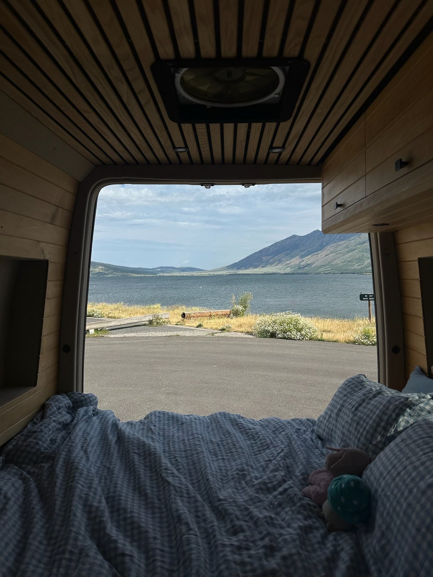  and comfortable passenger seating.|White RV rental camper van parked oceanfront with a deployed pop-top tent and open doors — photo 10