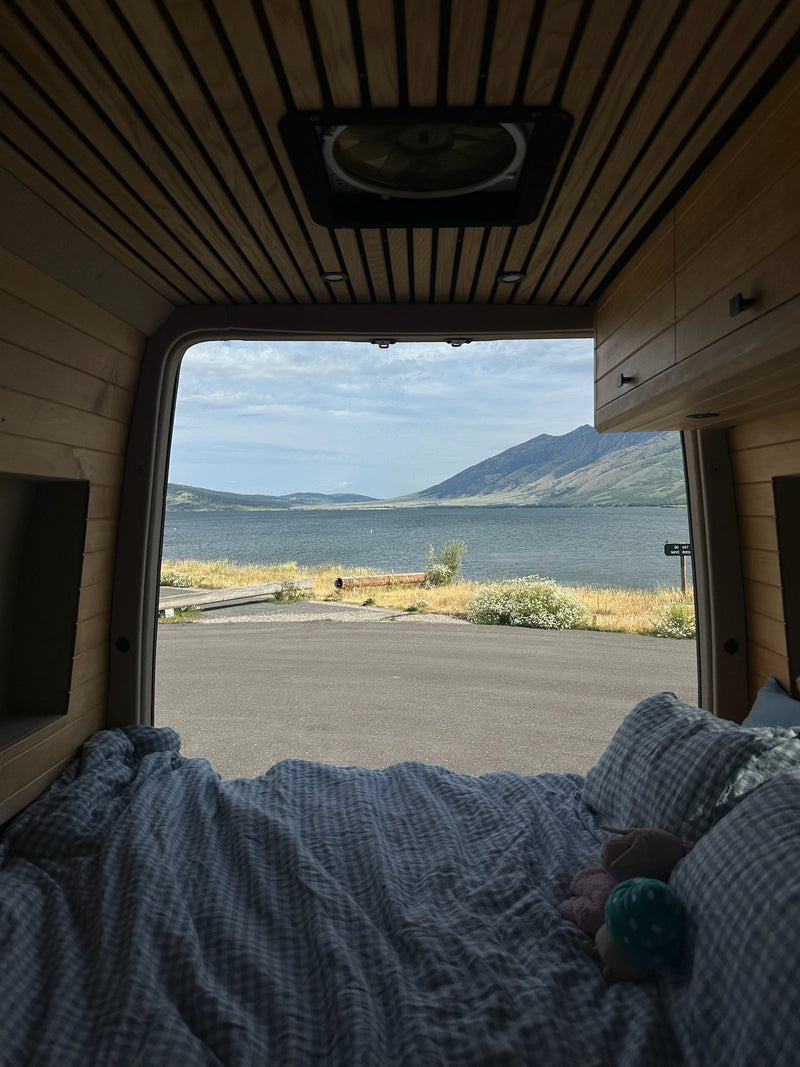  and comfortable passenger seating.|White RV rental camper van parked oceanfront with a deployed pop-top tent and open doors — photo 10