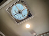 Overhead view in an RV rental: a ceiling MaxxFan ventilation system, bright light, and smoke detector provide comfort.