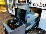 This RV rental features a convenient pull-out outdoor kitchen with a gas stove and Truma portable refrigerator for camping meals.
