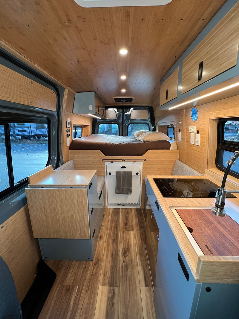 Modern **rv rental** interior: a cozy camper van with a wooden ceiling — photo 1